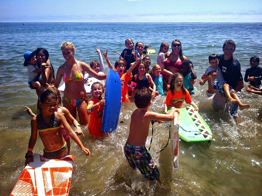 Aloha Beach Camp kids and their camp counselors playing in the ocean at Zuma Beach. Kids and teens who live in the Larchmont area of Los Angeles can enjoy a beach camp experience just like this when signing up for camp this summer. Aloha Beach Camp is providing free daily transportation to and from camp with a convenient bus stop at Third Street School in Hancock Park, just minutes from the Larchmont area.