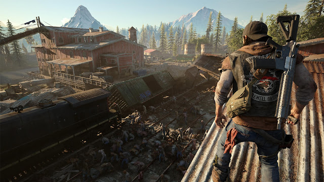 A man wears a backwards cap and a biker jacket as he surveys the area below him and vast amounts of zombies set to a stunning natural pine forest and moutains, from Days Gone