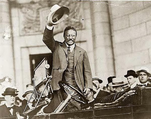 Roosevelt waving from car, 1909