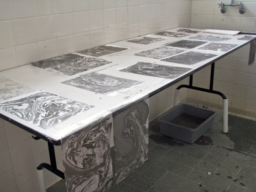 Marbled paper dries on a tab;e