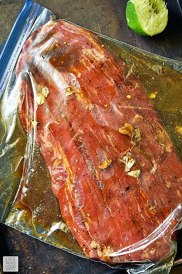 Flank steak marinating in the flank steak marinade in a zip top bag until ready to make cast iron flank steak