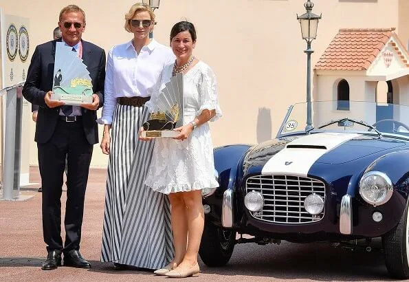 Princess Charlene wore Akris Punto striped flared skirt. Prince's Palace of Monaco after a parade in Monte-Carlo classical car event