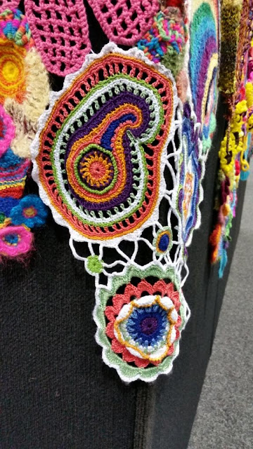Close-up of paisley and floral motifs which are joined by crochet chains.