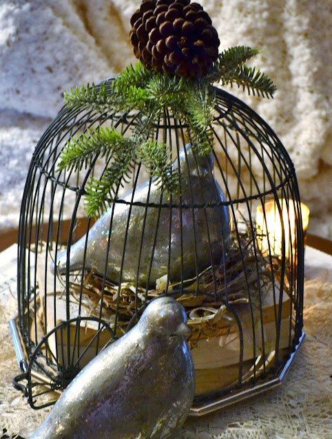 dove figurine sitting inside decorative bird cage