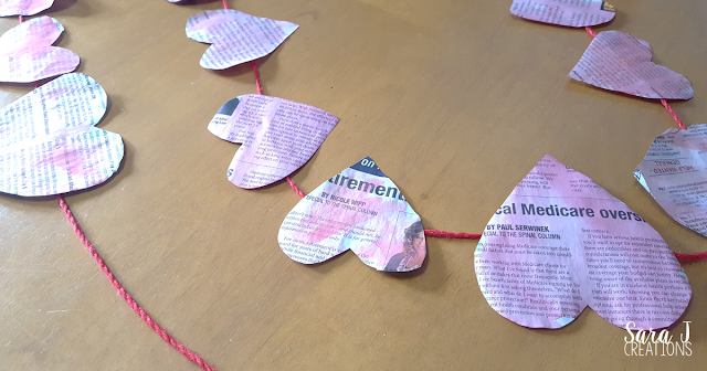 An easy newspaper heart banner craft. Perfect for #valentinesday or #february #crafts #hearts