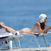 Helena Christensen catches some rays in a blue bikini