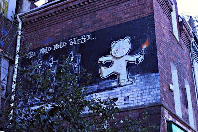 Banksy artwork The Mild, Mild, West in situ on the side of a building. 