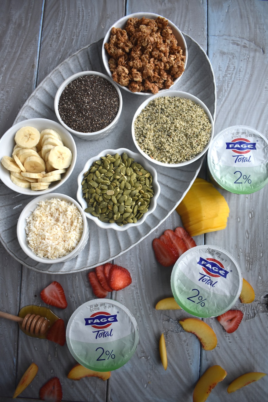 Build Your Own Yogurt Bowl Bar has tons of toppings for yogurt including fruit, honey, nuts, seeds, cereal, granola and more for a fun breakfast that the whole family will love and that is great for entertaining! www.nutritionistreviews.com