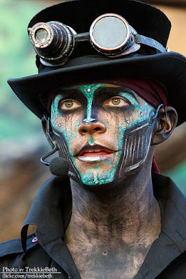 Men's Steampunk makeup for costumes or cosplay or halloween. Cyberpunk style robot with bright blue face paint and metal jaw.
