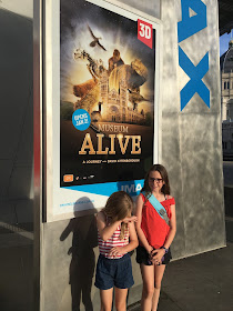 Girls in front of Museum Alive IMAX sign Melbourne