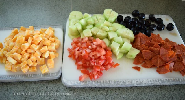 pasta salad ingredients - pepperoni, cheese, tomato, olives, cucumber