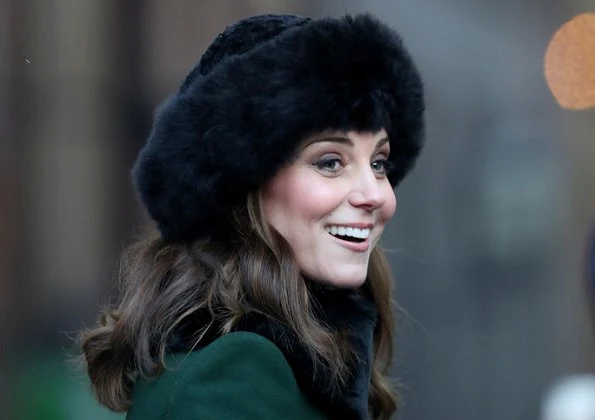 Kate Middleton wore a new bespoke Catherine Walker coat and dress. Duchess accessorised her coat with a faux fur collar and faux fur cuffs from Troy London