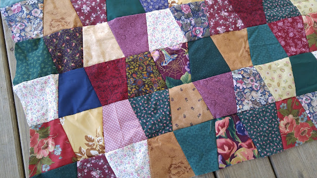 Tumbler quilt made with ugly fabrics