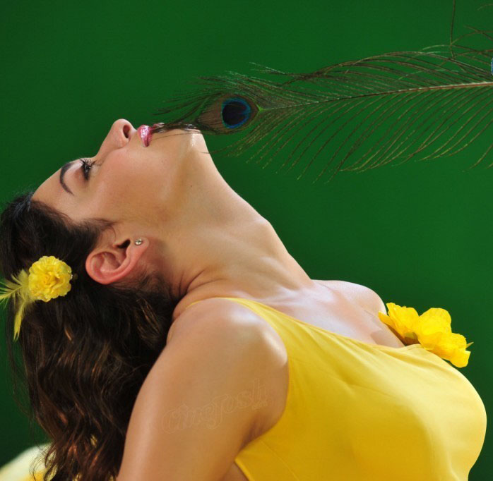Tamannaah Bhatia playing with feather, Tamannaah Bhatia in yellow sexy dress, Tamannaah Bhatia seductive photos