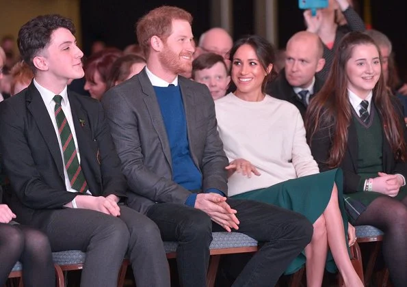 Meghan Markle wore Victoria Beckham cashmere sweater, Mackage Mia sand belted wool coat, Manolo Blahnik shoes and carried Charlotte Elizabeth bag