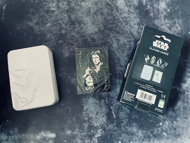 Star Wars Playing cards next to storage tin and box