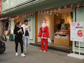 young Chinese woman dressed up as Santa