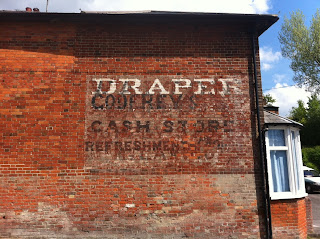 Multiple ghost signs in Easterton, Wiltshire