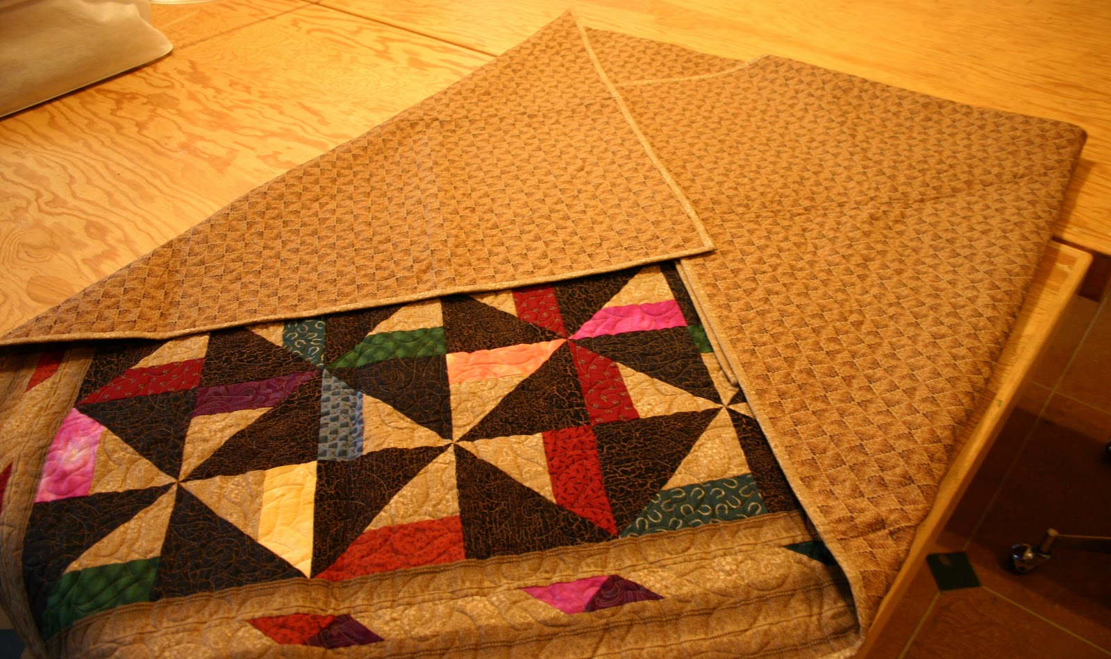 Today in Kenogami Folding a Quilt for Storage