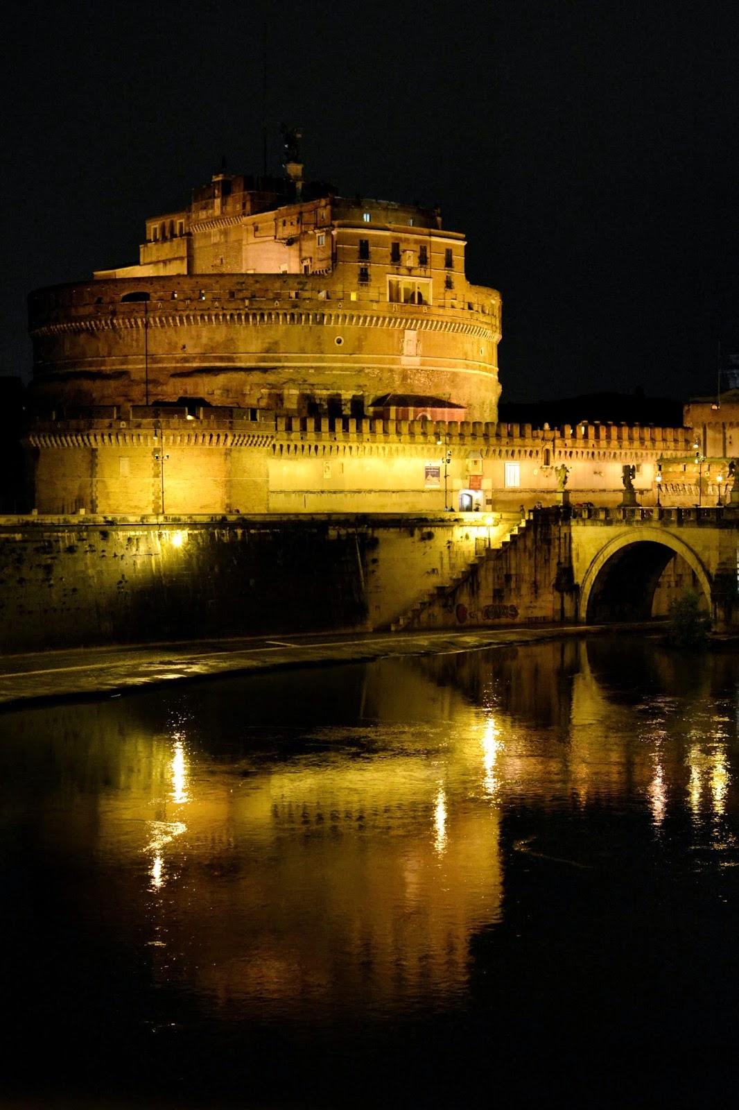 Night time photograph of Castel Sant'Angelo and the River Tiber