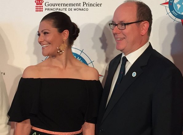 Crown Princess Victoria and Prince Albert of Monaco attended the "Ocean Conference. Princess Victoria wore  floral printed skirt. carried Anya Hindmarch Gold Metallic Clutch