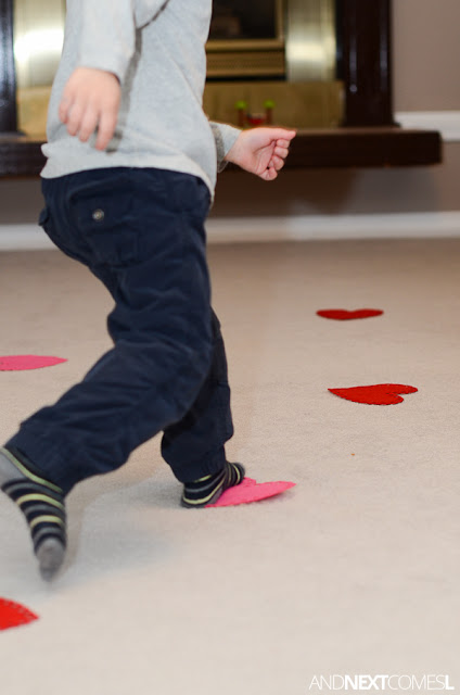 Close up of a preschool child stepping on pink and red hearts as part of a Valentine's Day activity Close up of a preschool child stepping on pink and red hearts as part of a Valentine's Day activity