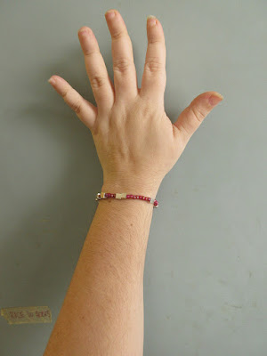 A hot pink chemistry bracelet featuring Avogadro's num