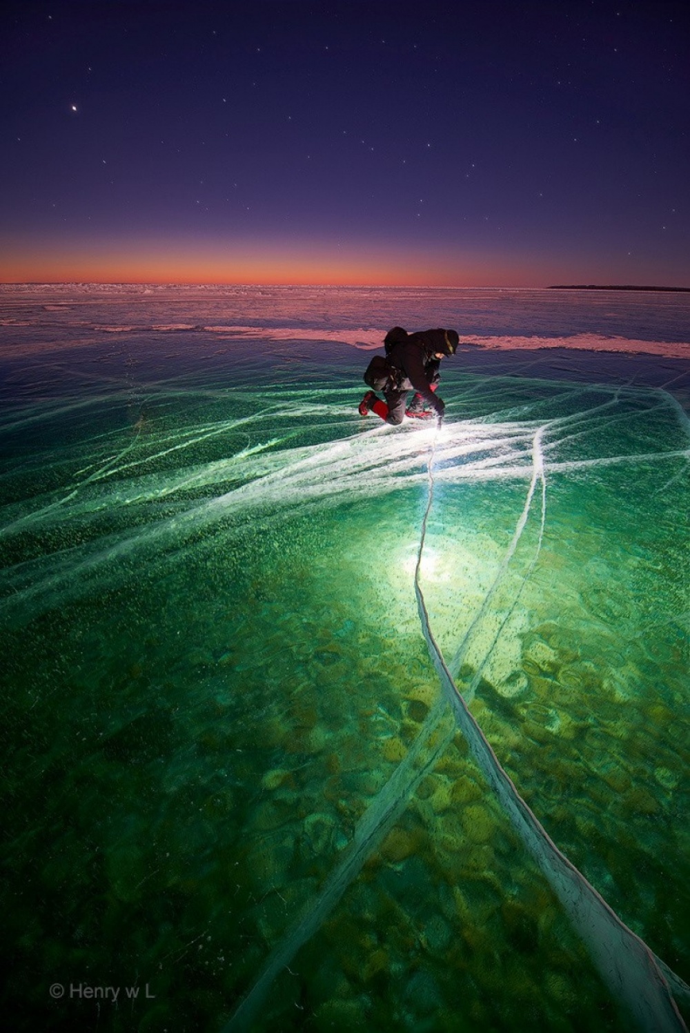 The 100 best photographs ever taken without photoshop - Man with Flashlight on Ice creates Beauty