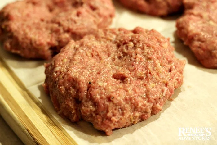 Slow Cooker Salisbury Steak patties formed and ready for browning on a cutting board