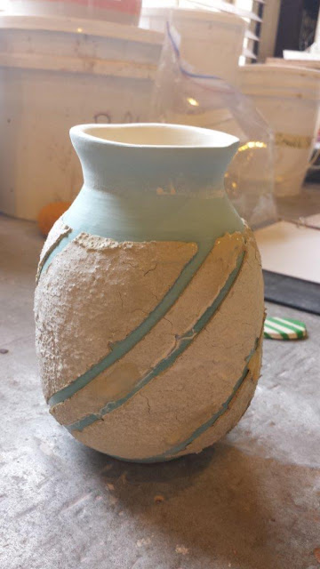 Ceramic hand thrown pottery vase prepared with sacrificial slip for naked raku firing.