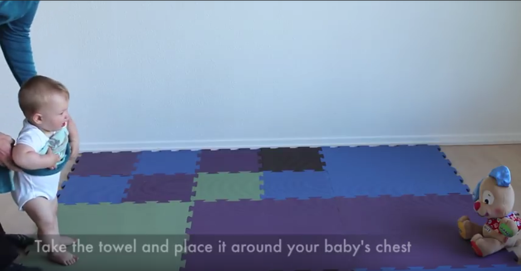 teaching baby to walk with towel