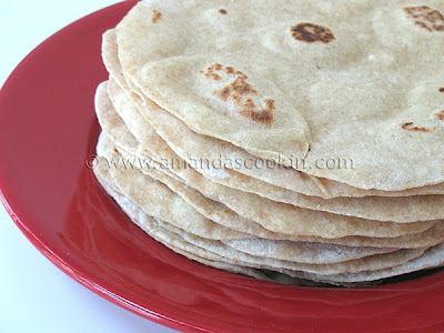 A close up photo of a stack of low fat homemade flour tortillas.