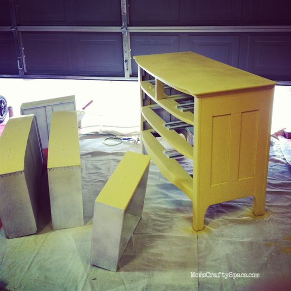 dresser painted yellow and drying in garage to vent 