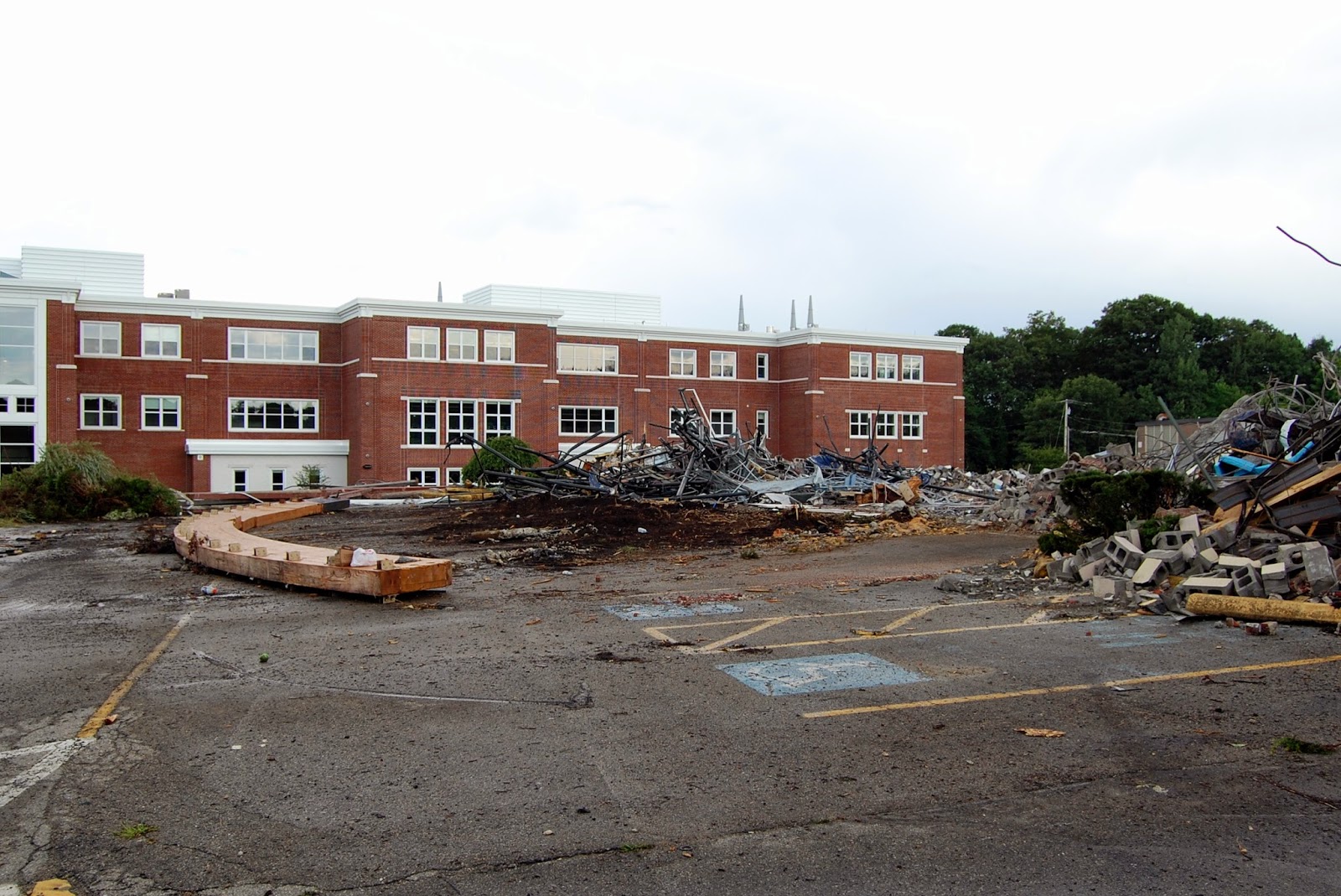 closer to the piles that remain, the new school building becomes the dominant view