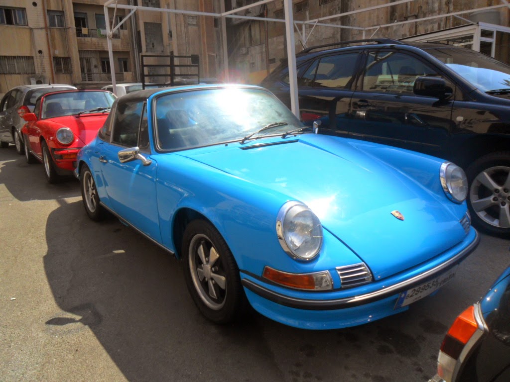 People and Logo Of blue vintage cars in Beirut.