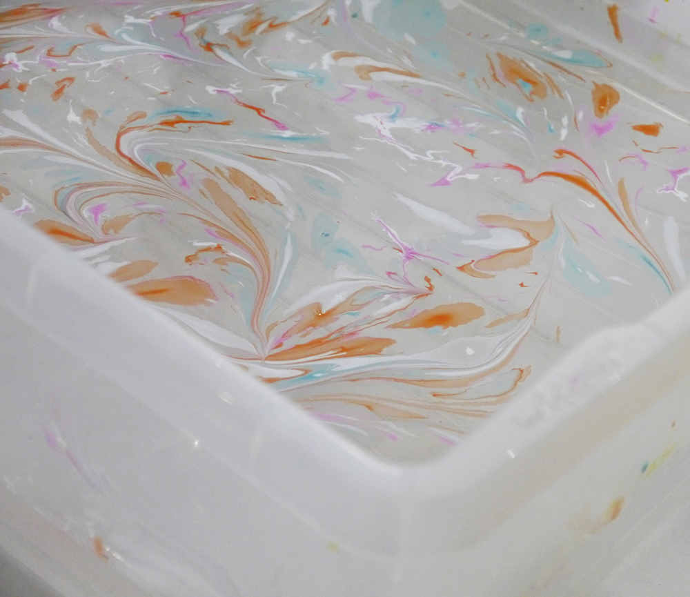 Fabric marbling patterns on water solution in white, orange and blue Mischke Lingerie, Hill Street Deisgn House, silk marbling technique, silk marbling workshop, lingerie making workshop, Edinburgh events, craft blog, how to