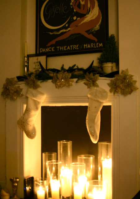 holiday mantle decor and candles in the fireplace