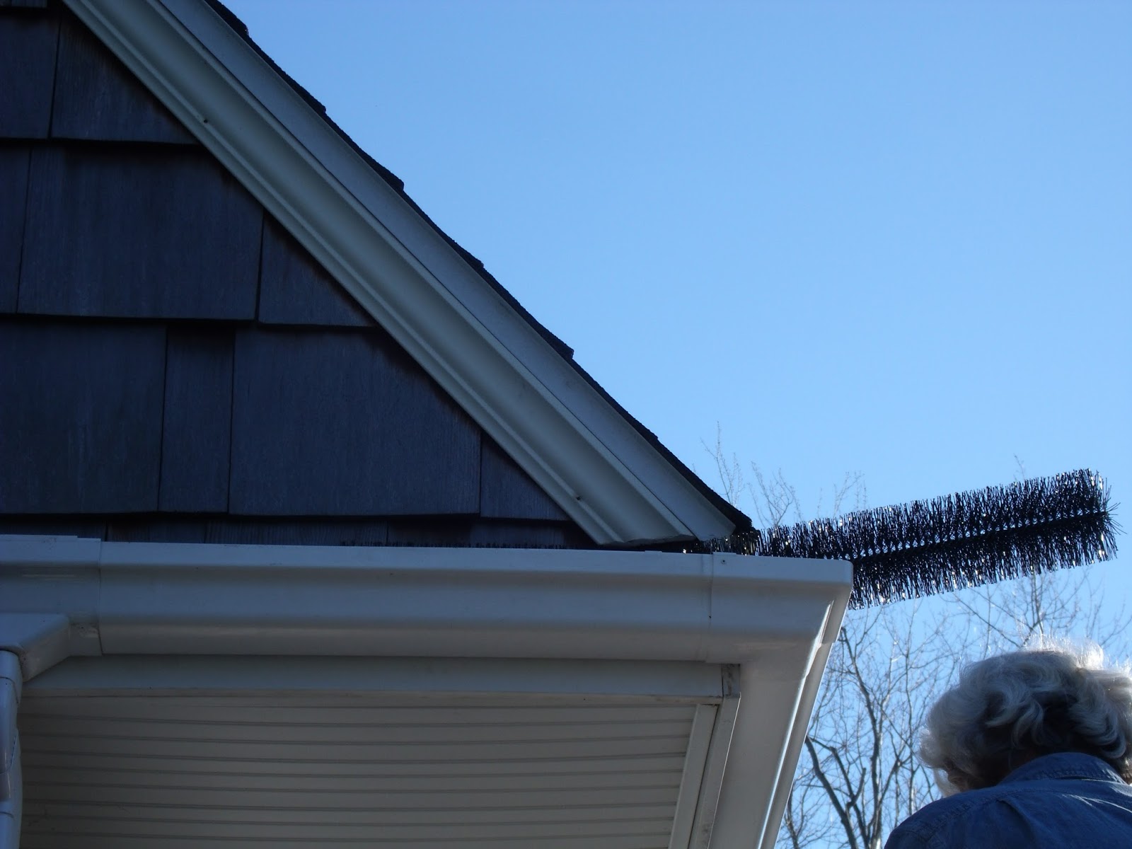 Gear Acres at Top of the Hill Installing Gutter Brush in the Eavetroughs