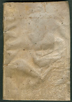 A photograph of a limp vellum binding - plain and somewhat warped in appearance.