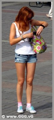 Tanned girl in denim mini shorts on the street