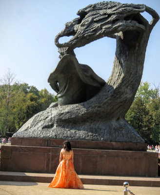 Mika Okumura in front of a statue of Chopin in Łazienki Park in Warsaw, Poland