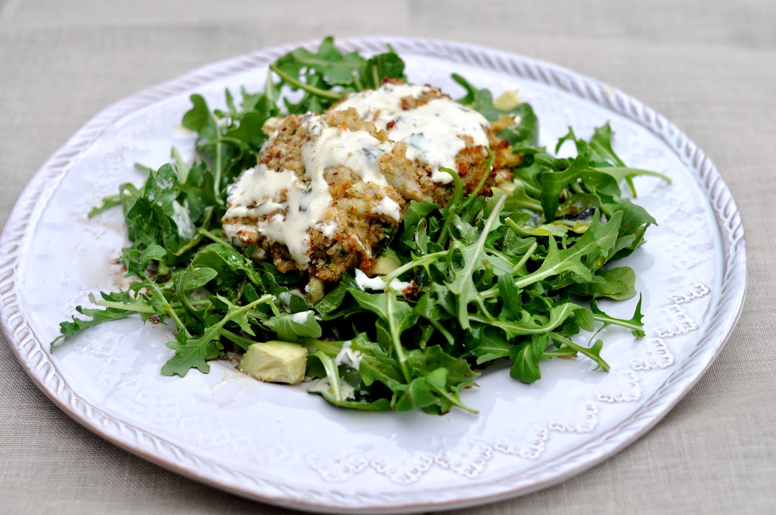 The Pearce's Kitchen Baked Crab Cakes with Lemon Mustard Sauce over a bed of Arugula