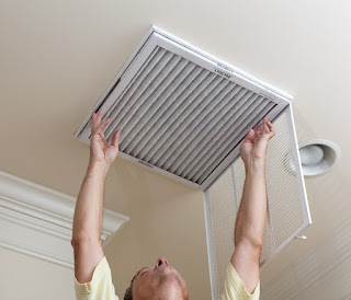 A person changing an air filter