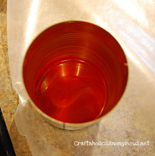 Then using a small cooking pan filled with a couple inches of boiling water, place the can in the pan and melt the crayons. {you could also use a candle warmer to do this}the crayons melt pretty quickly. *note: it only takes a few crayons to fill a bottle cap!
