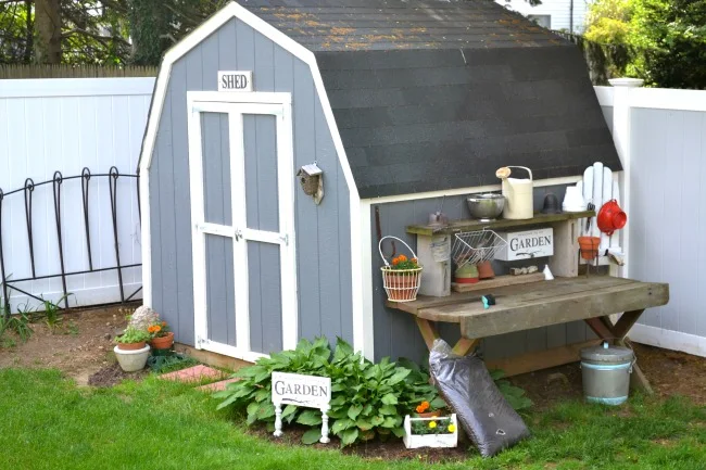 The side of the shed is the perfect place for a potting bench with repurposed organization and storage. Homeroad.net