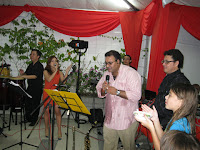 The host belting out a song with the band