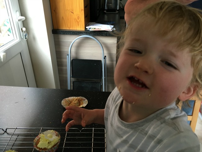How-to-Make-Cup-Cakes-With-A-Toddler-lots-of-sprinkles-around-toddlers-mouth