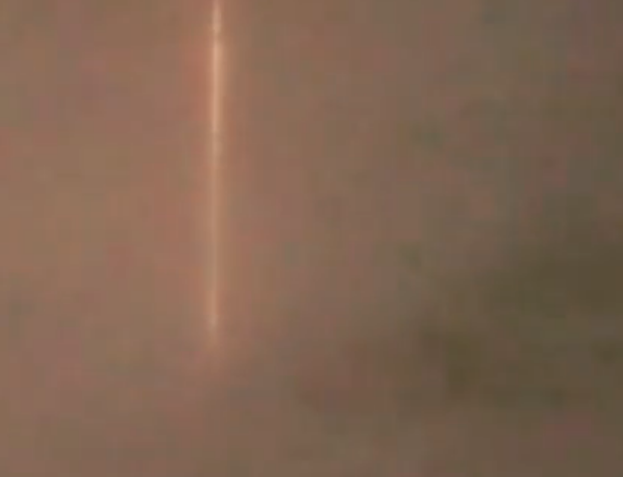 Huge and long red laser or plasma beam coming down from space over Canada.
