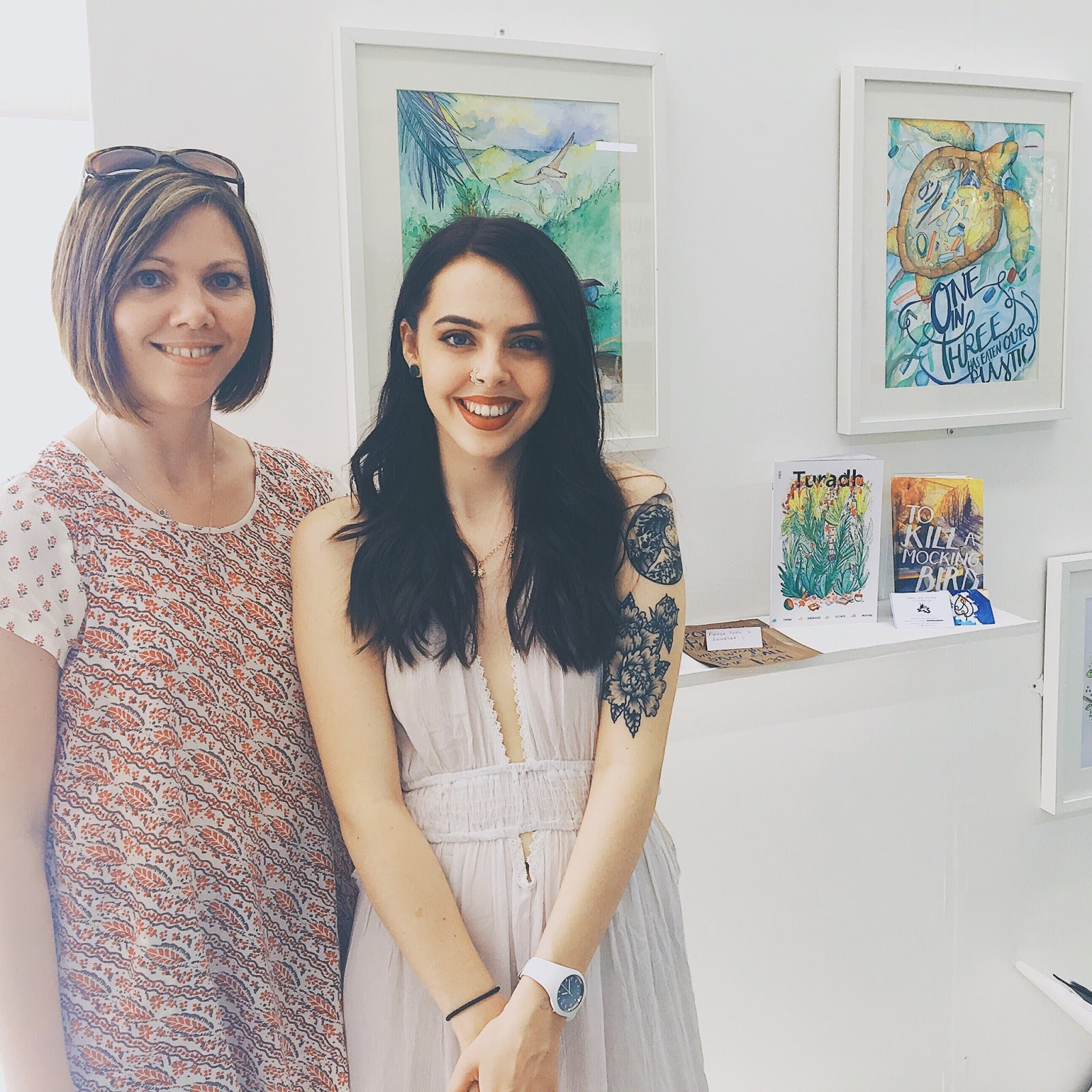 girl standing in front of artwork