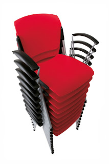 large stack of red waiting room chairs with black arms and chrome legs